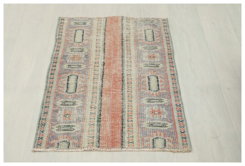 Full top view of the 2'0" x 3'3" vintage Anatolian rug with rust, blue, and beige geometric patterns