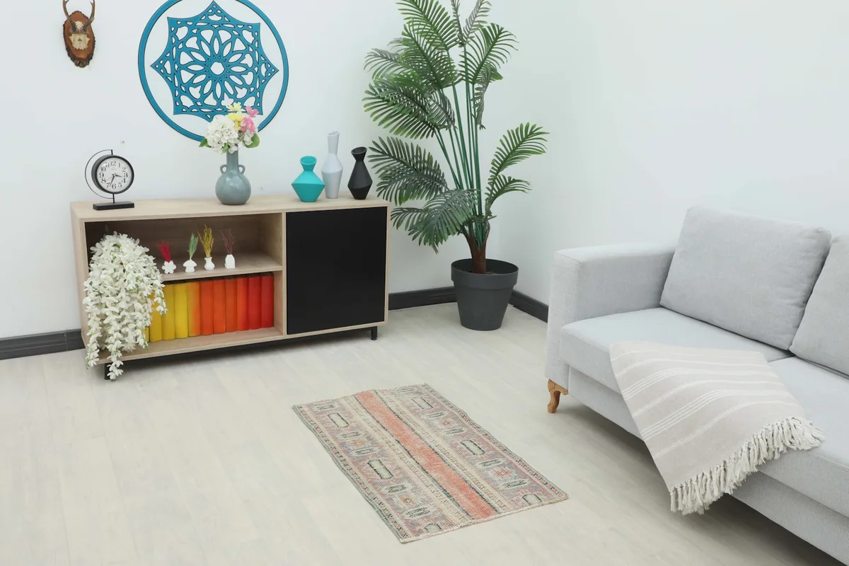 Vintage Anatolian rug displayed in a living room setting, showcasing its size and colors