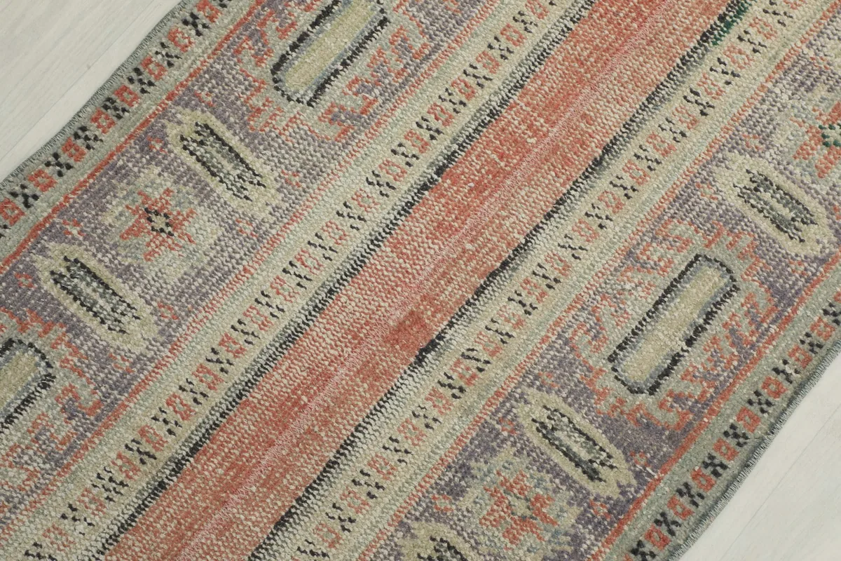 Diagonal close-up view emphasizing the striped and geometric patterns on the rug