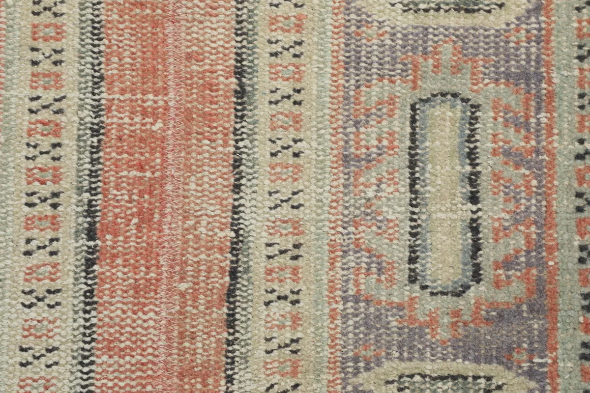 Detailed view of the low wool pile and the intricate knotting of the rug