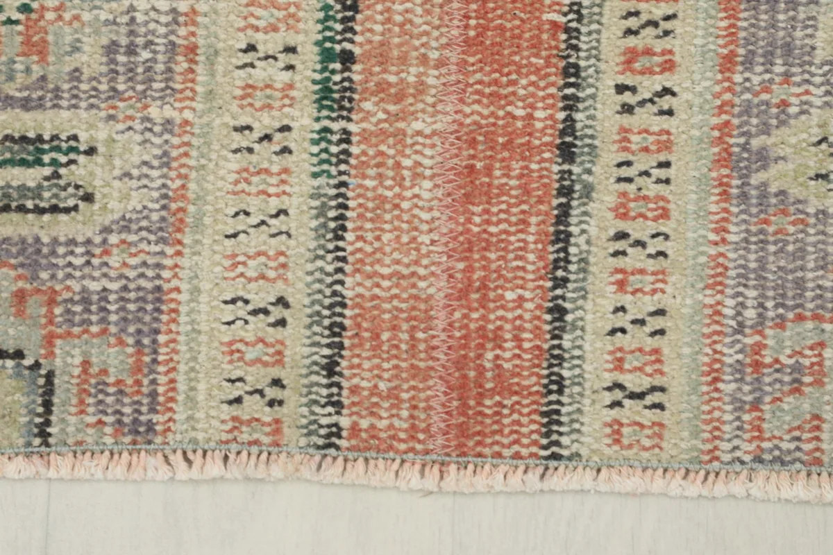 Close-up of the rug's fringe and the edge, showing the hand-finished details