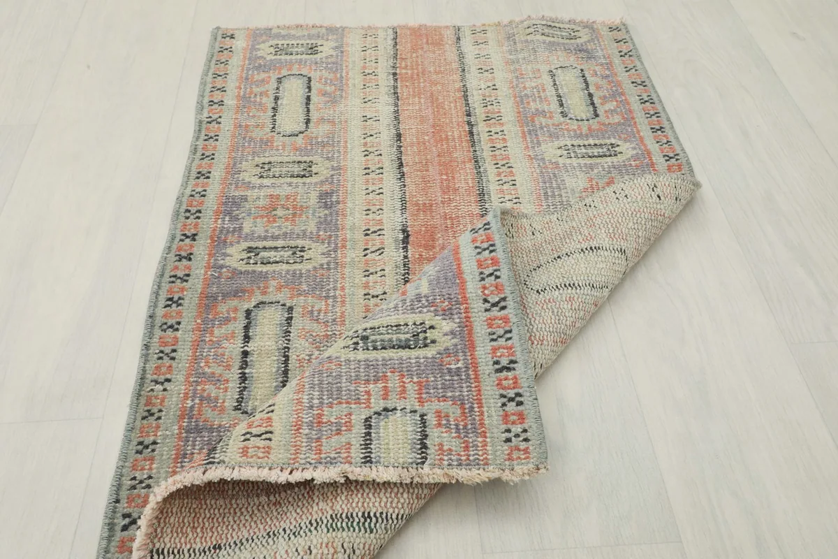 The rug partially folded, illustrating its flexibility and construction