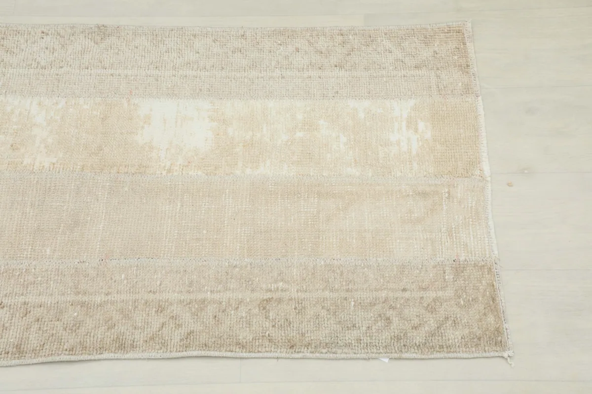 Close-up of the runner's border, showing the geometric patterns and distressed texture.