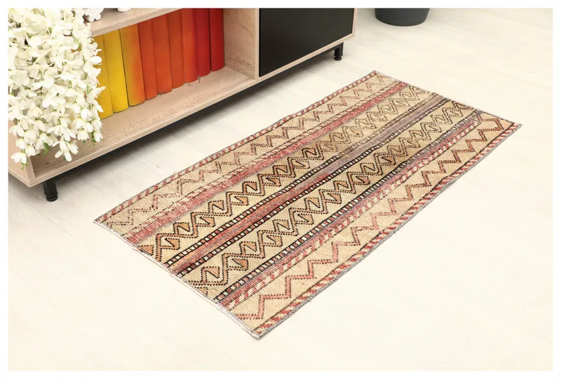 Full top view of the beige and rust geometric striped rug on a white background