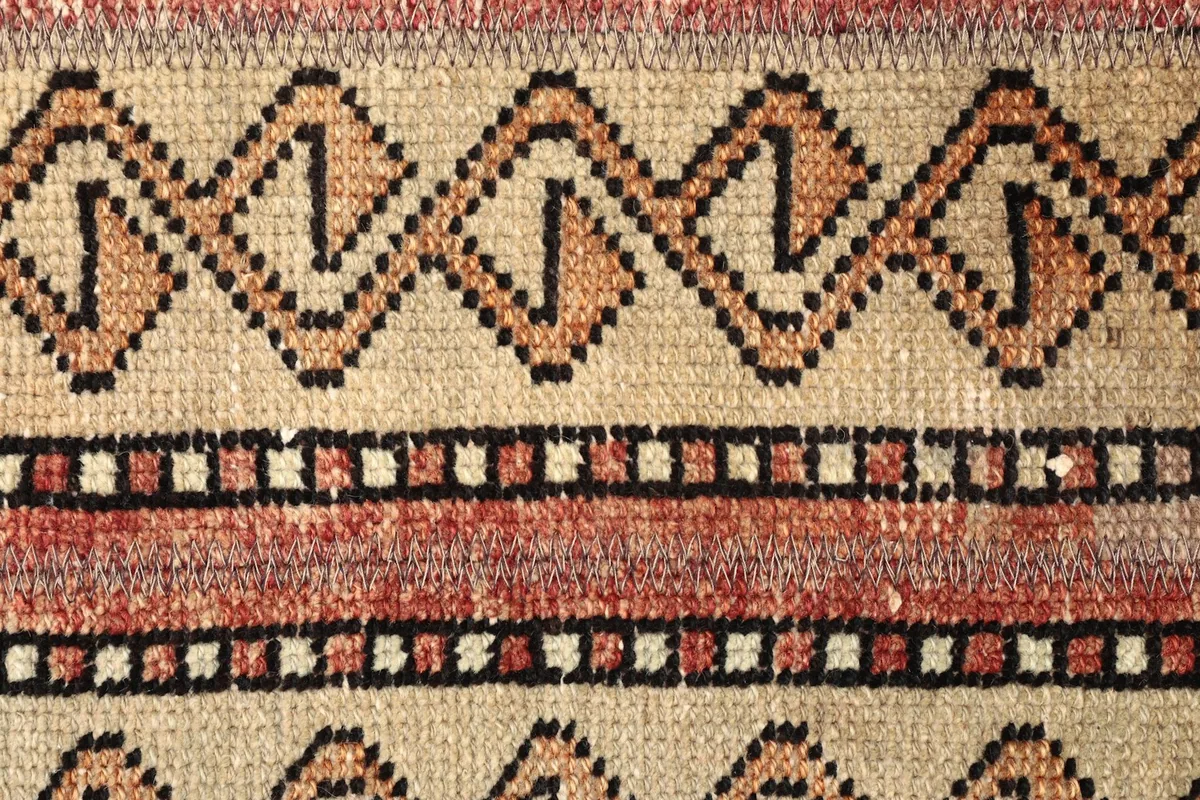 Detailed view of the rust and black geometric patterns within the stripes