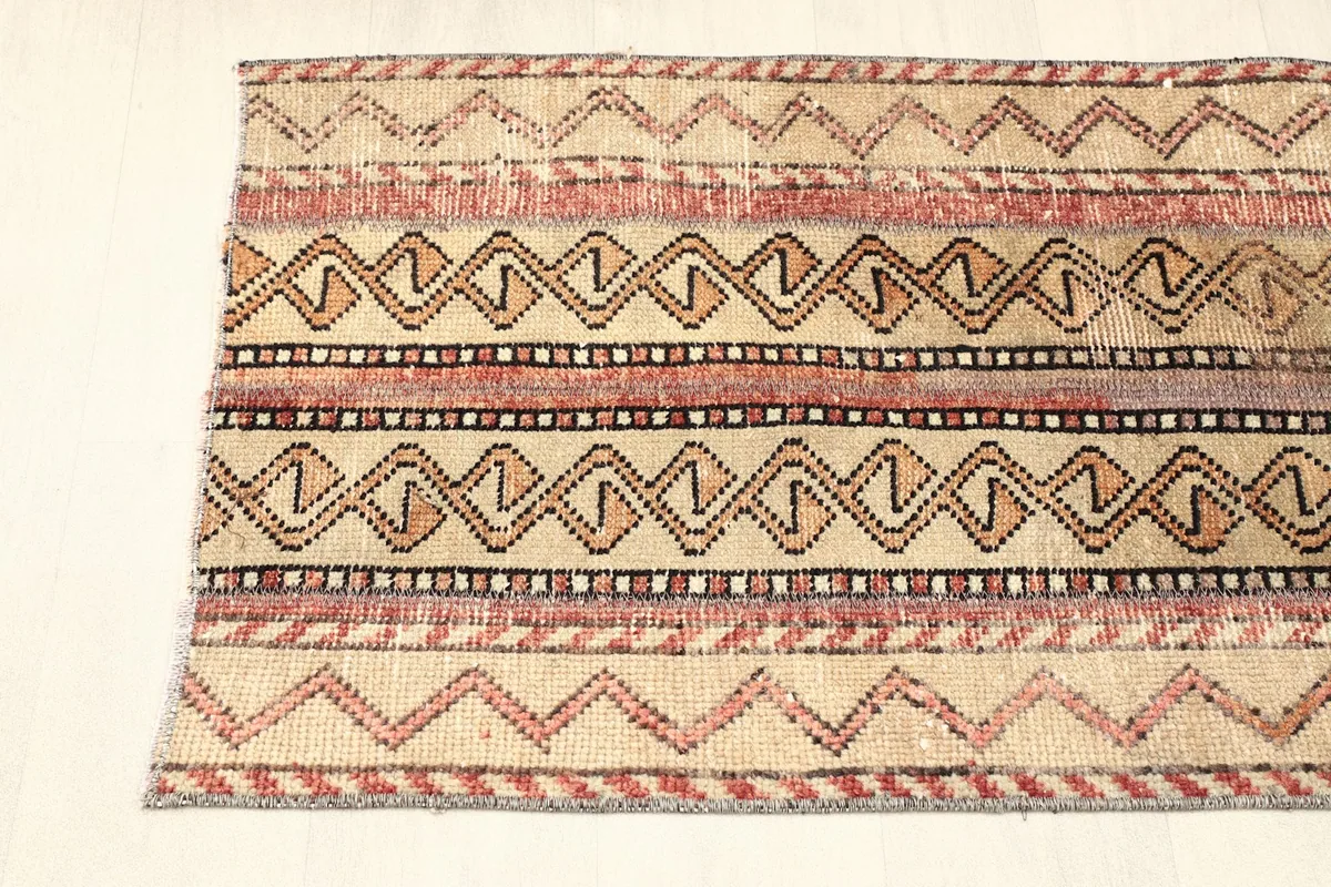 Close-up of one end of the rug, showing the consistent geometric design