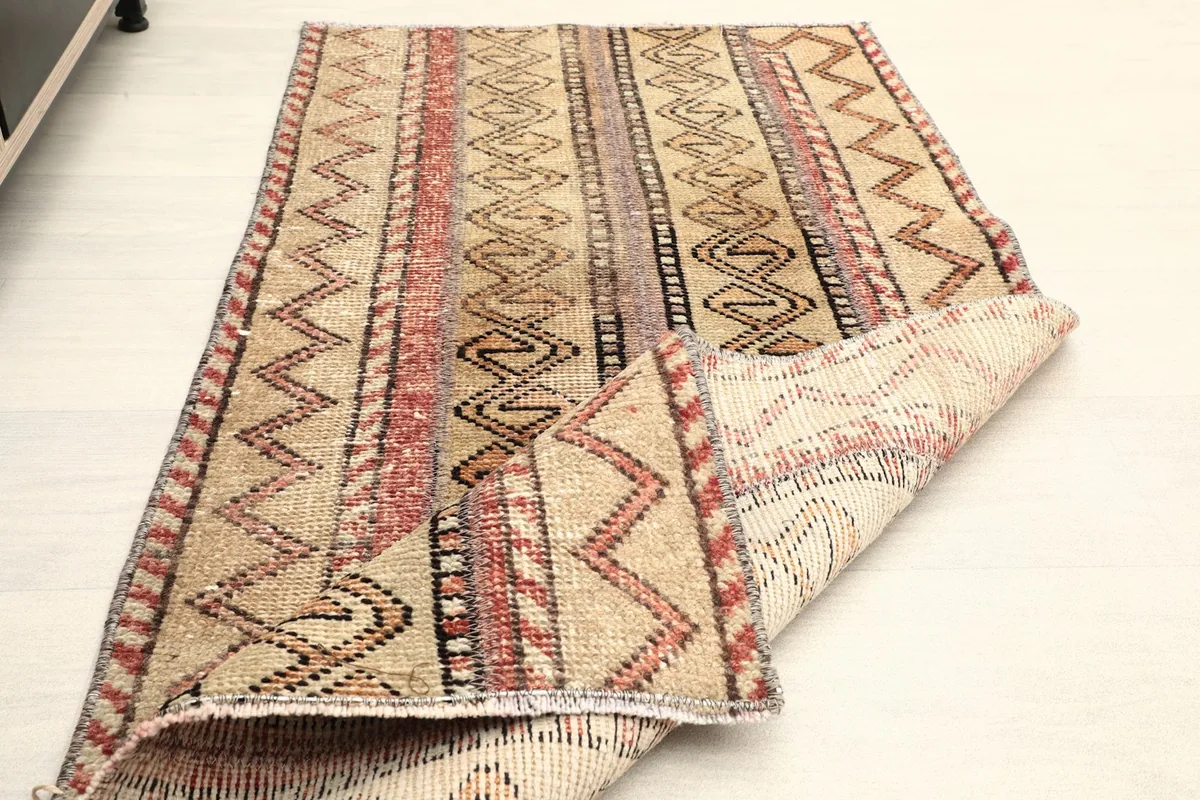 The rug partially folded, displaying both the pile and the reverse side