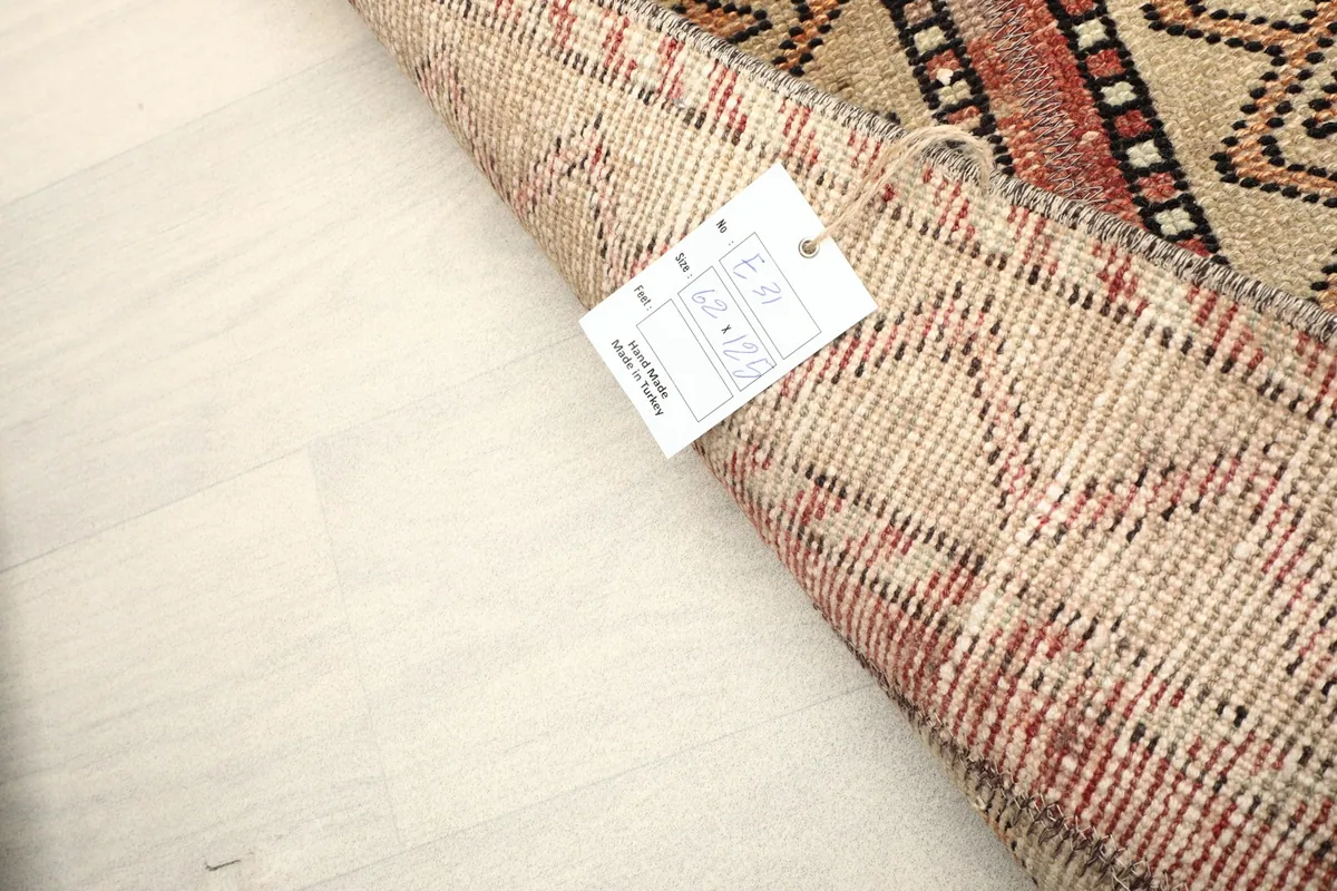 Rolled rug with product tag visible, indicating its origin and materials