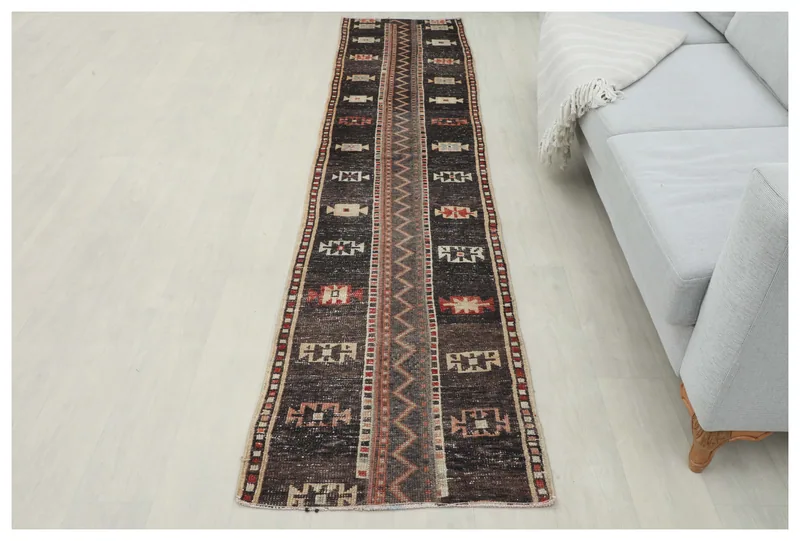 Full top view of the 2x10 brown geometric vintage runner rug on a white background.