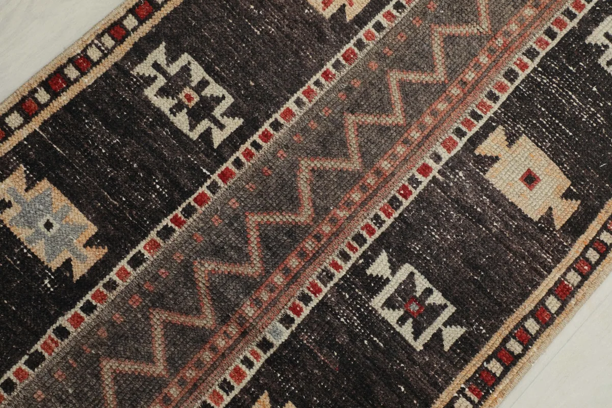 Overhead angled shot highlighting the central zigzag pattern and surrounding geometric shapes.