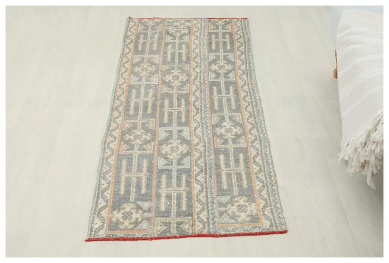 Full top view of the gray and beige geometric vintage runner on a white floor
