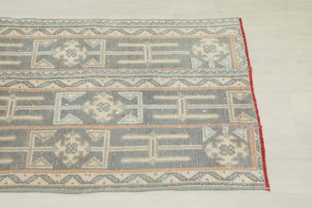 Close-up view of the runner's gray, beige, and rust geometric patterns