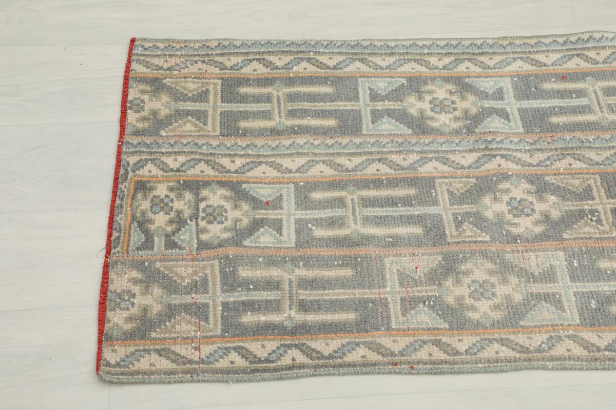 Detailed view of the vintage runner's tribal motifs and color variations