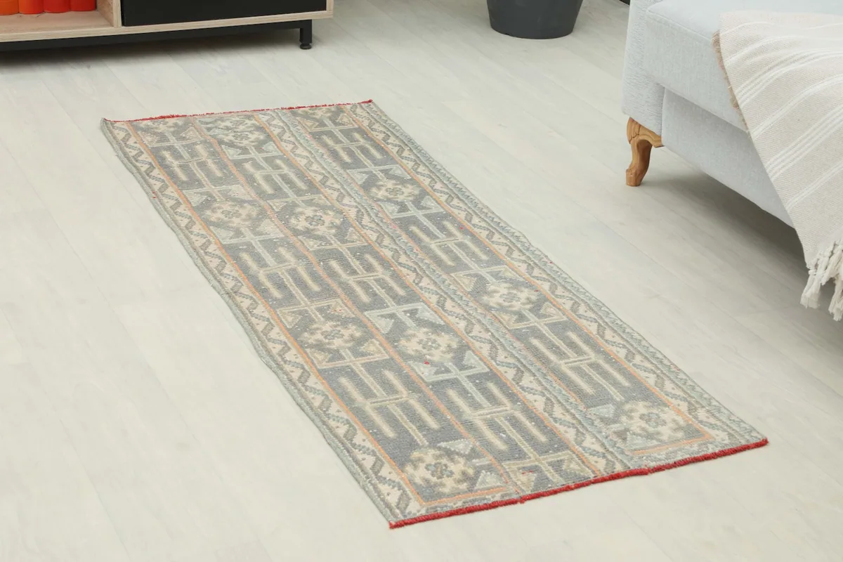 Overhead view of the gray and beige runner rug, showing its full length and pattern