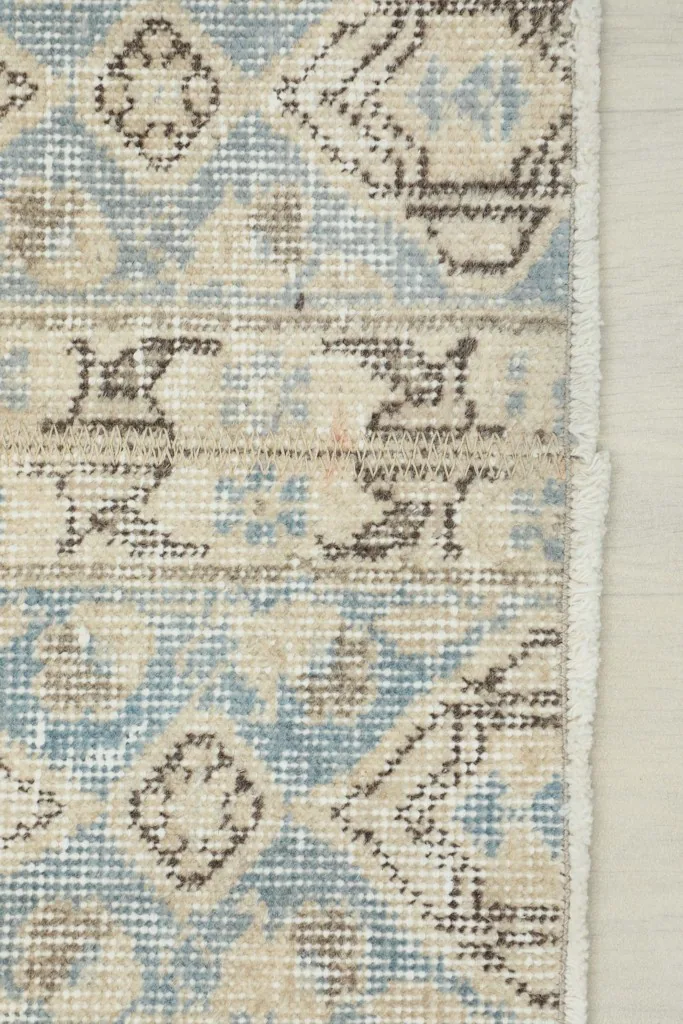 Close-up of the edge of the runner, showing the subtle border and fringe detail.