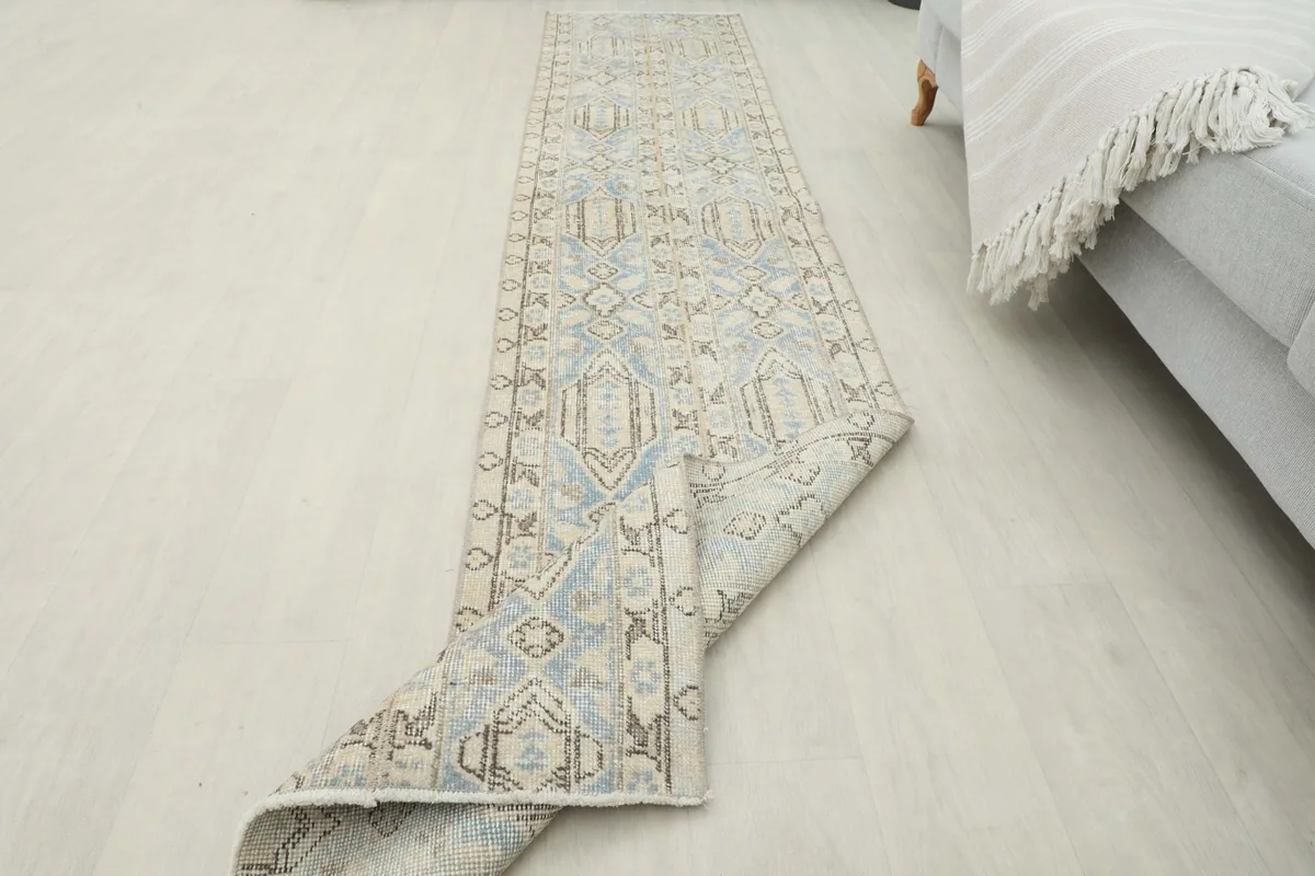 Runner partially folded to illustrate its flexibility and thickness on the floor.