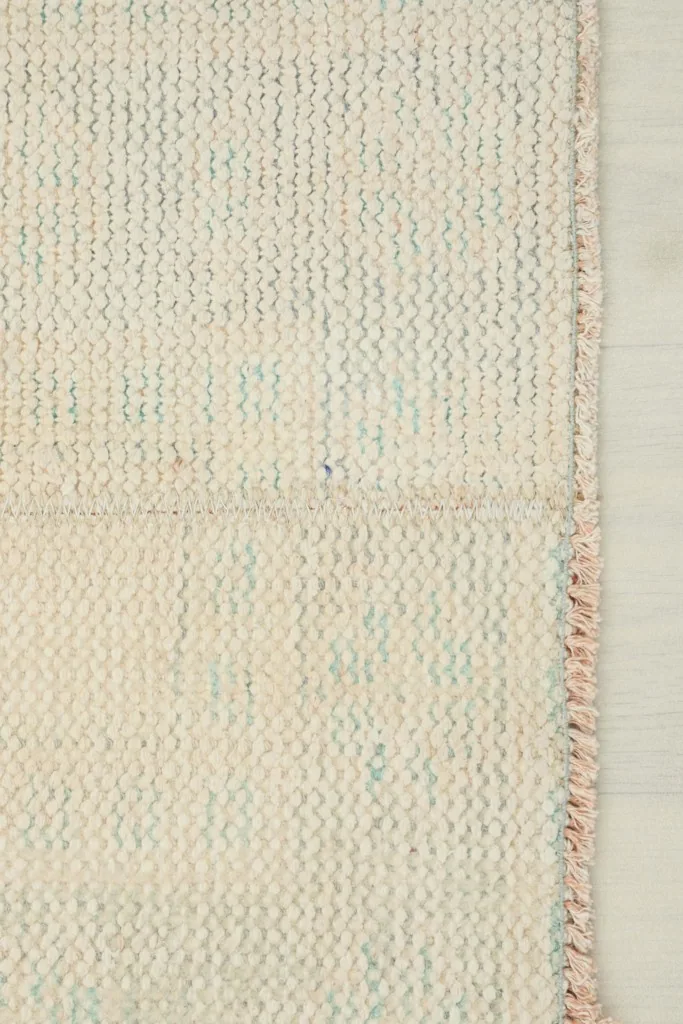 View of the back of the runner rug, showing the cotton foundation and fine knotting.