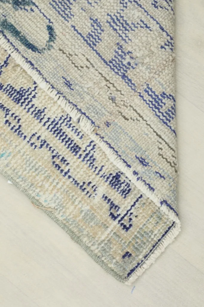 View of the rug's back and foundation, showing the hand-knotted construction and cotton threads.