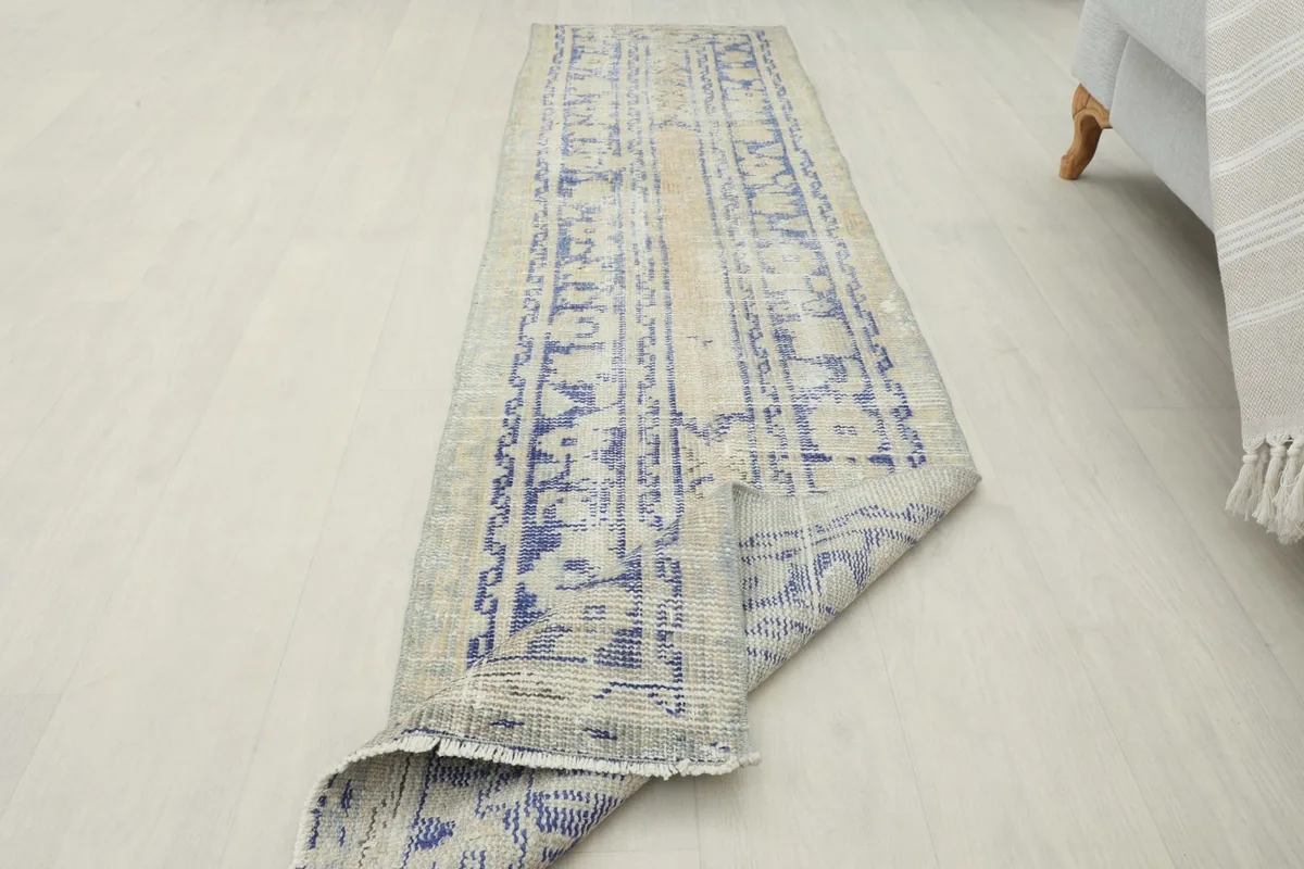The runner rug partially folded, showcasing its flexibility and the overall design.