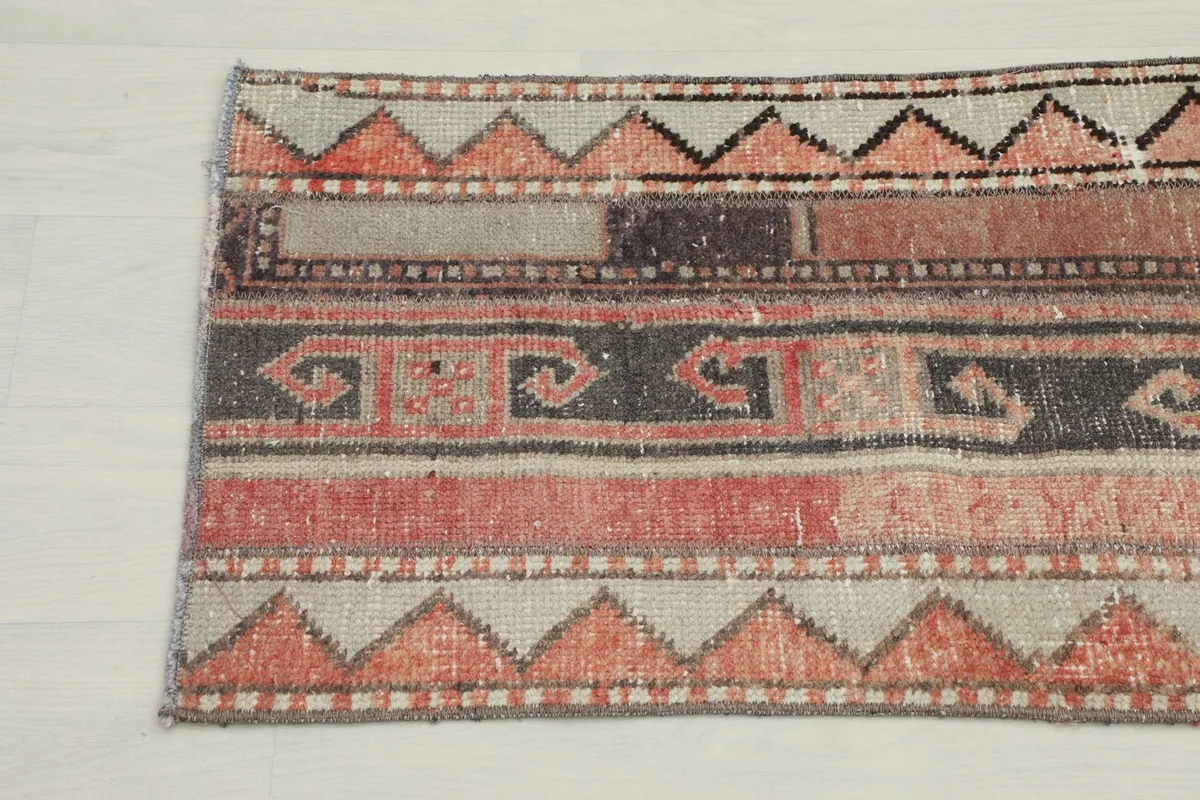 Another close-up of the rug's end, revealing the intricate geometric and tribal patterns.