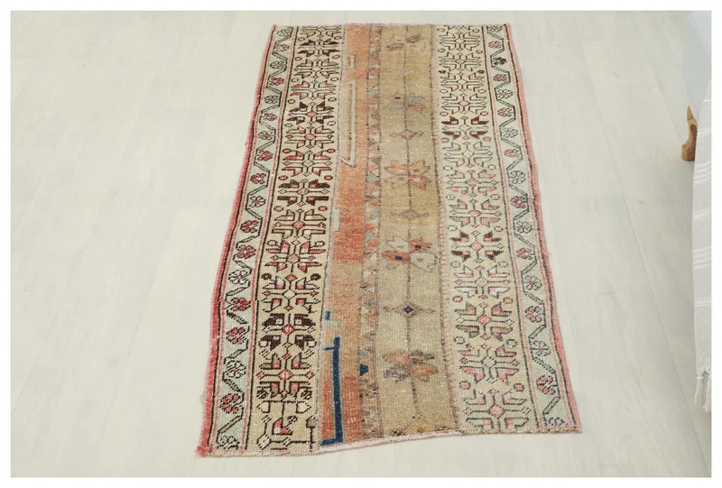Full top view of the beige and rust vintage Anatolian runner on a white background.