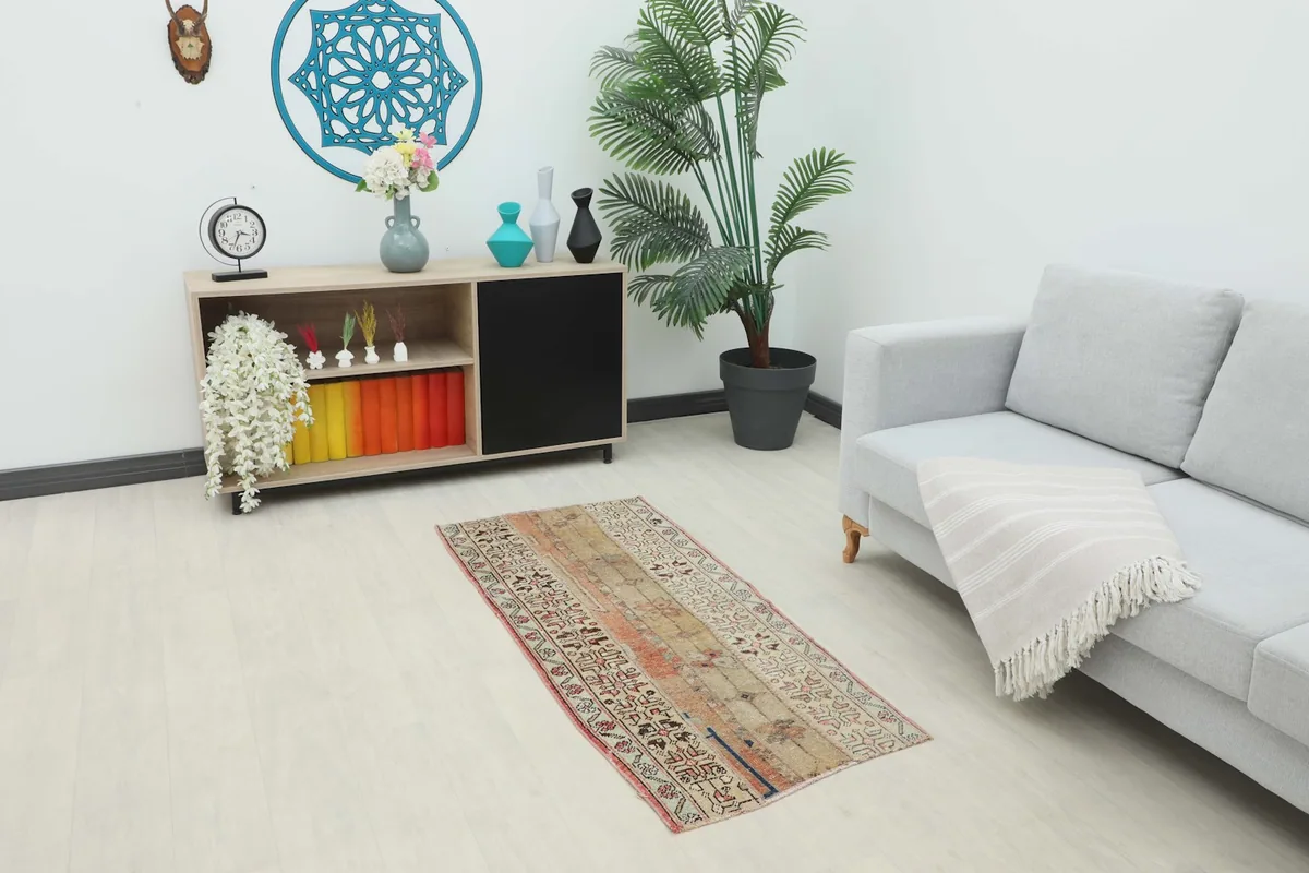 Vintage beige and rust runner placed in a modern living room setting.