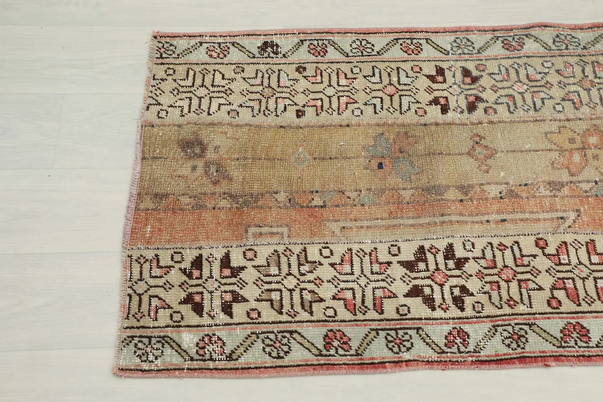 Close-up of the lower section of the rug, showing geometric patterns and color variations.