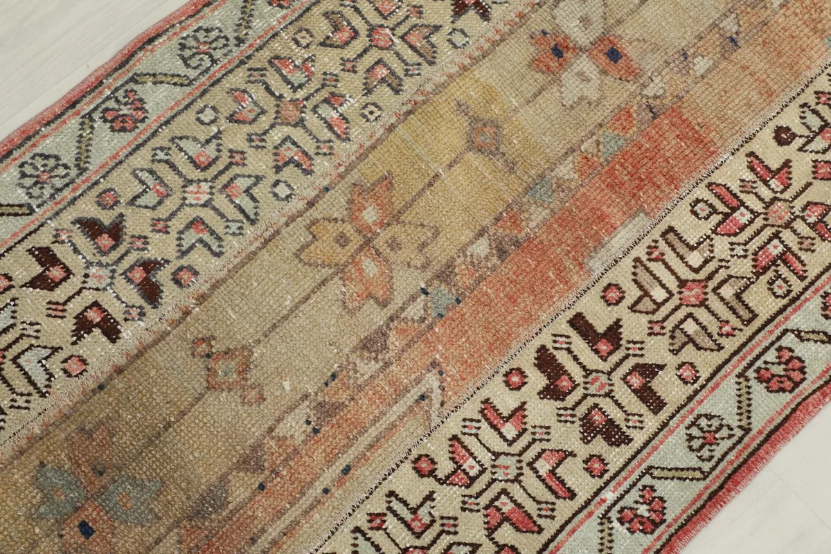 Overhead angled view of the rug's central design and border details.