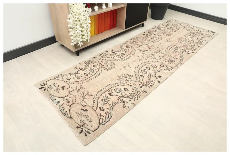 Full top view of the beige and brown vintage Anatolian runner rug on a white background.