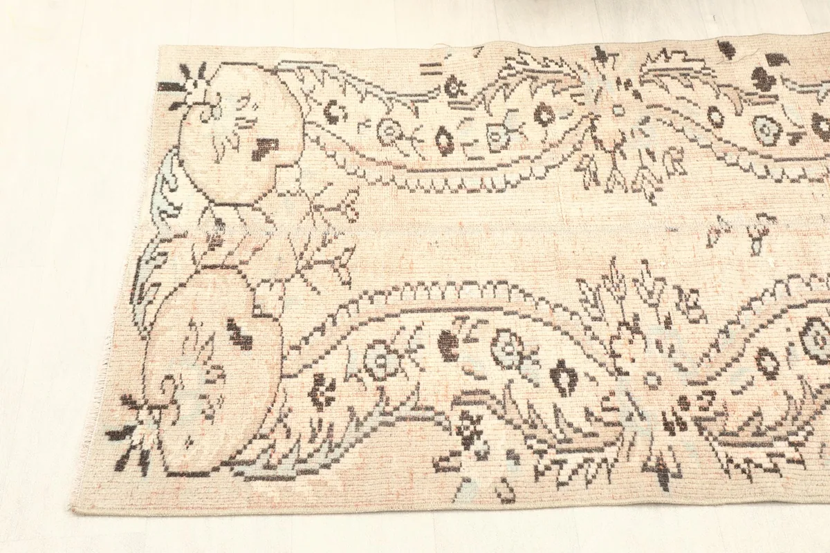 Angled shot of one end of the runner, emphasizing the curving floral designs.