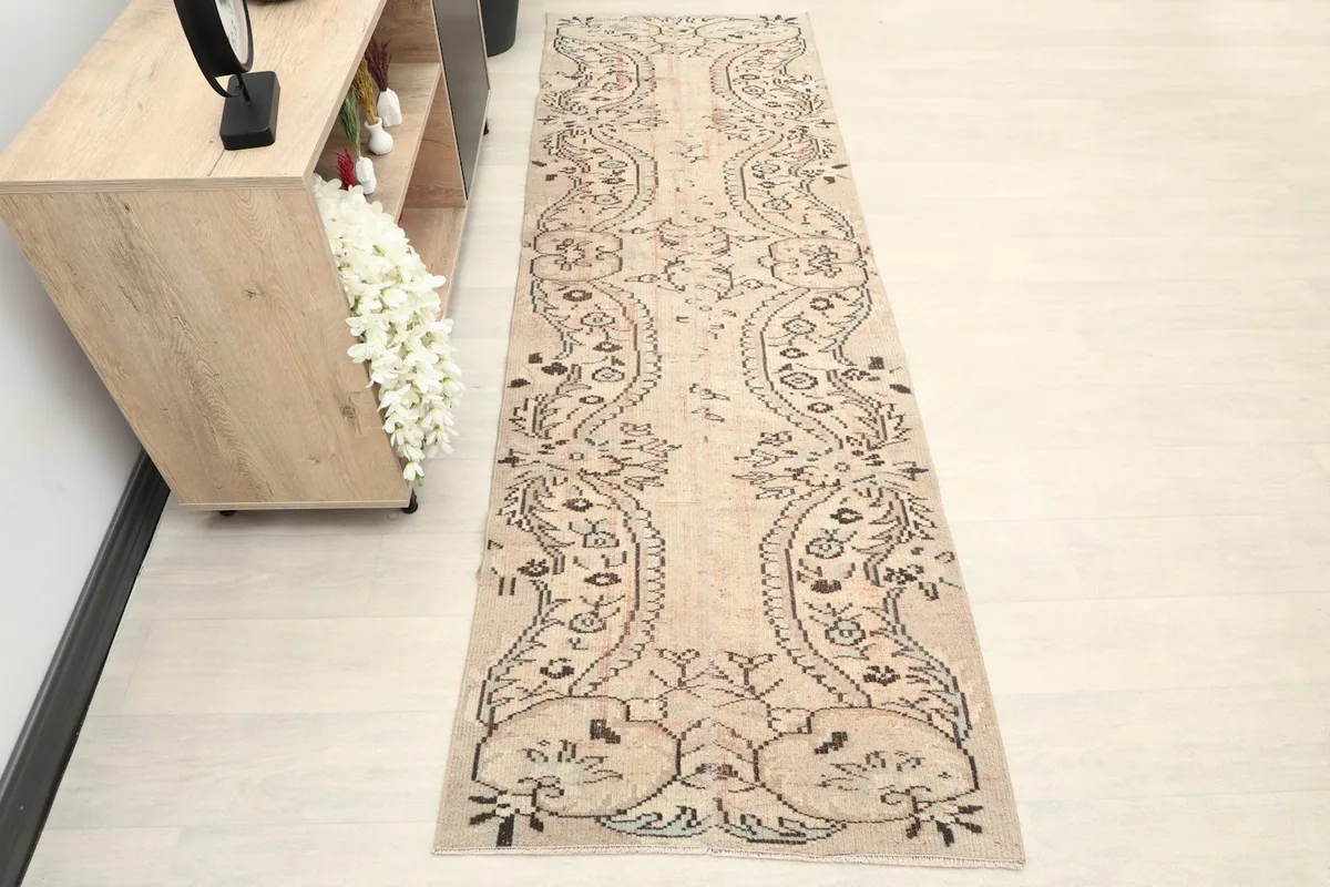 Vintage runner rug displaying its full length in a modern hallway setting.