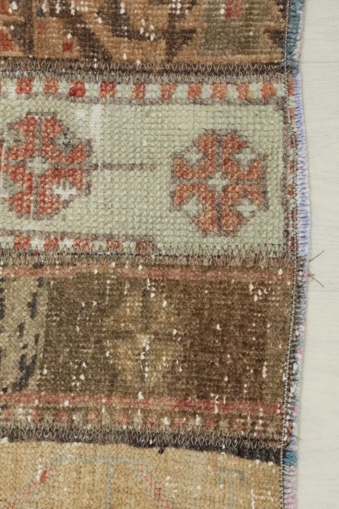 Close-up showing the low wool pile and hand-knotted texture of the rug