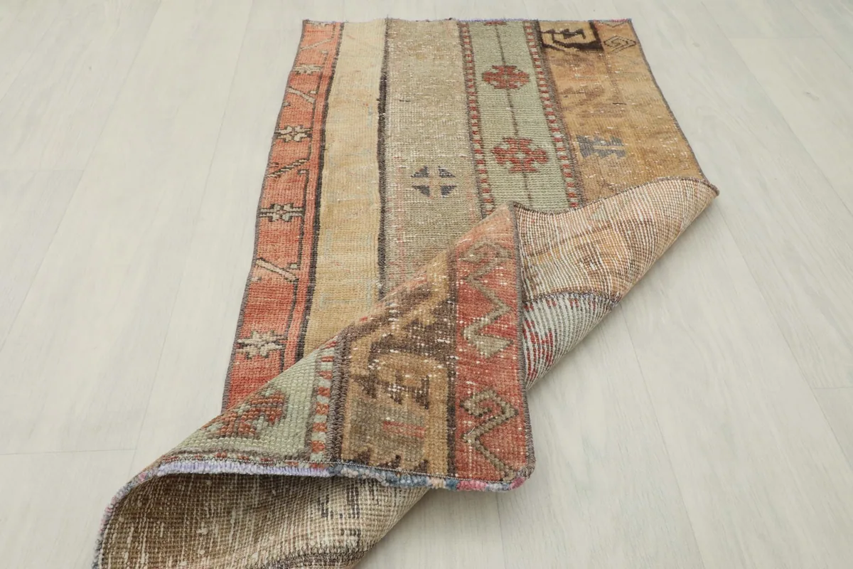 Rug partially folded, revealing the reverse side and construction