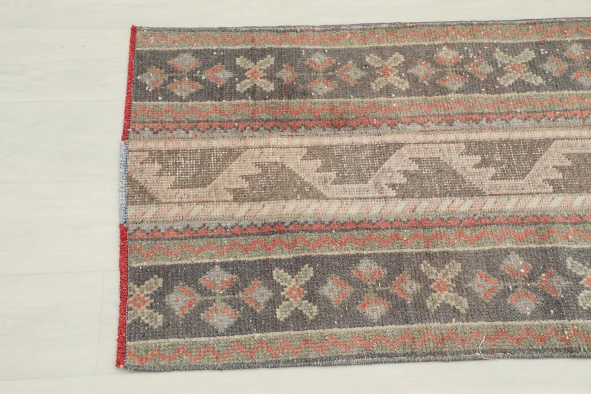 Close-up of the other end of the rug, detailing the tribal motifs and color variations.