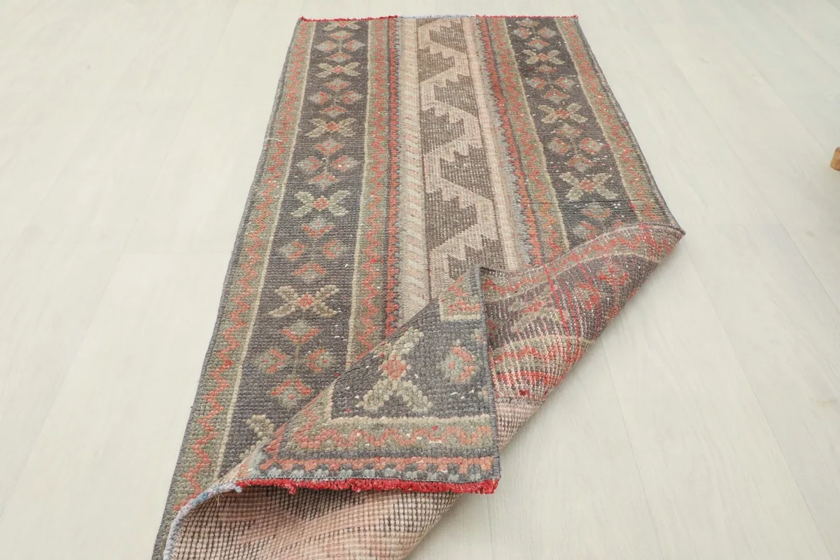 The rug folded to reveal its back and front, demonstrating its flexibility and construction.