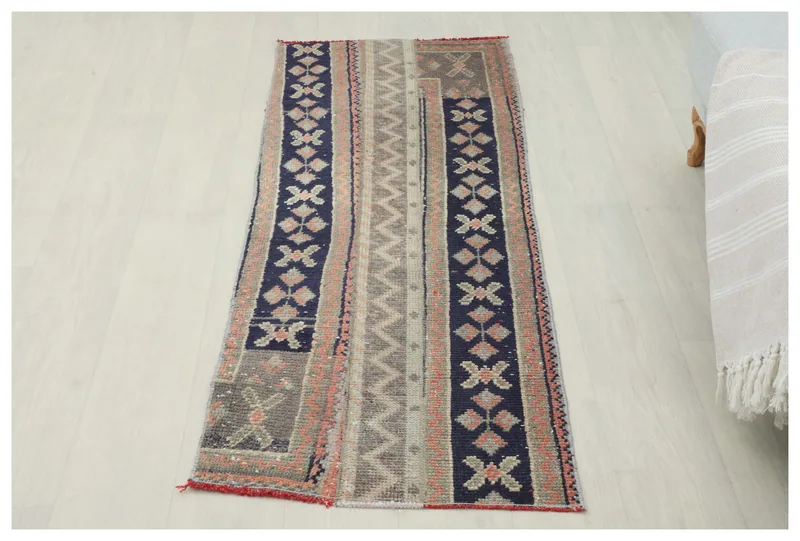 Full top view of the 1'11" x 5'3" vintage Anatolian runner rug with navy, rust, and gray geometric stripes
