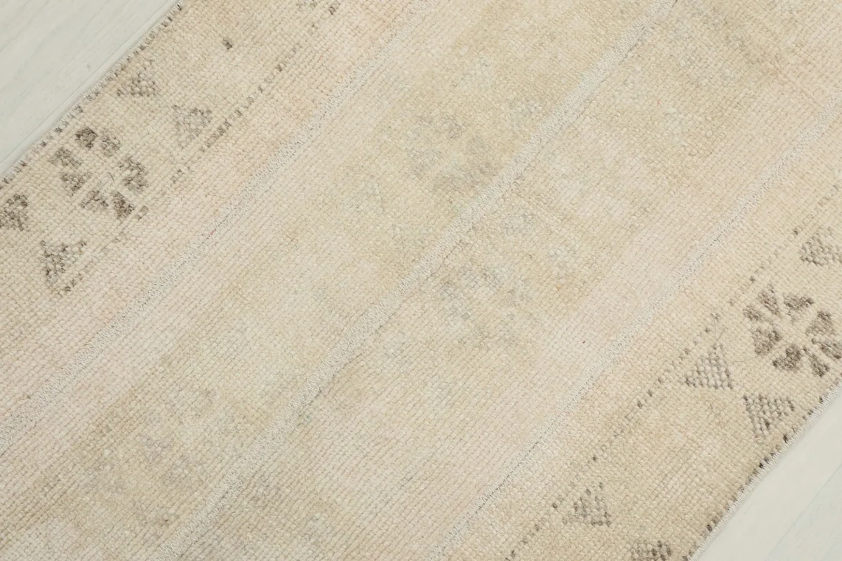 Angled view of the rug's surface, revealing the low pile and intricate geometric patterns