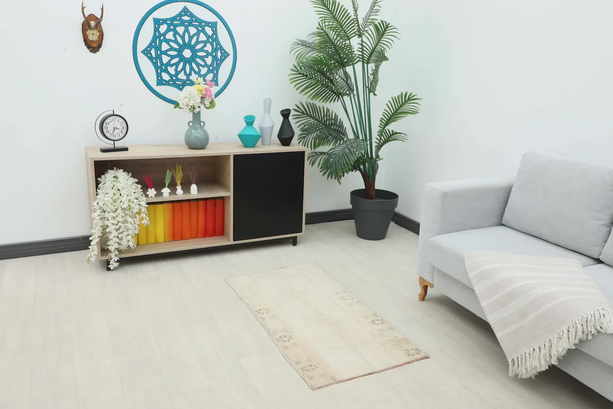 Overhead view of the cream rug in a modern living room with light furniture