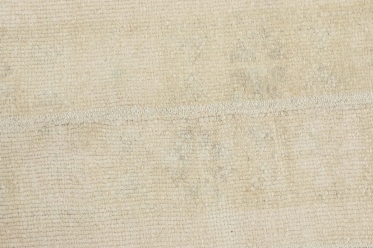 Detailed shot of the rug's low wool pile, showing the natural fiber and weave