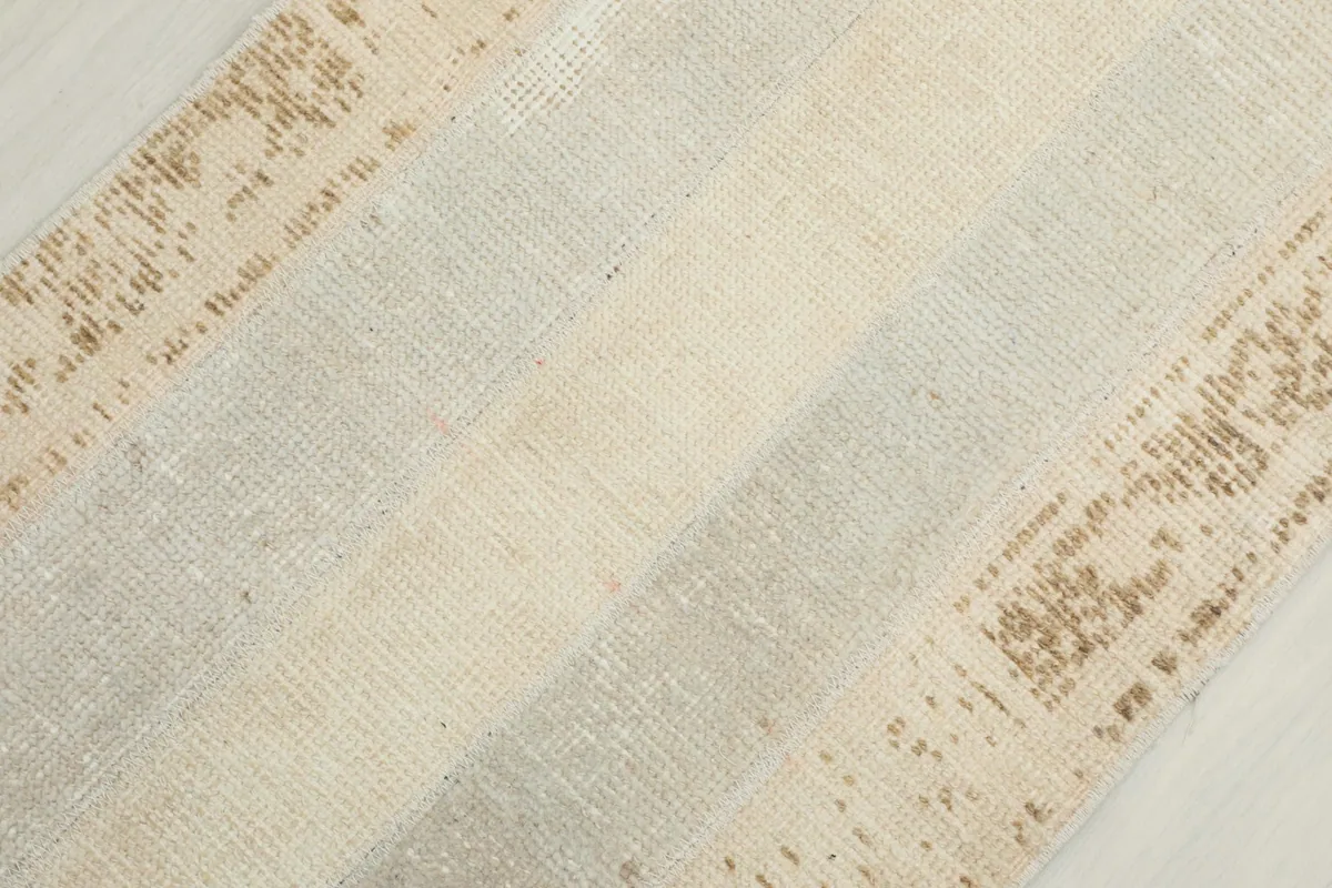 Diagonal close-up of the distressed wool pile and geometric patterns