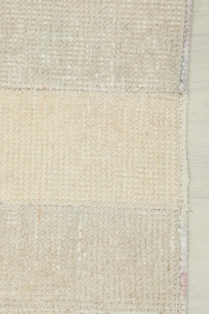 View of the back of the rug showing the hand-knotted cotton foundation