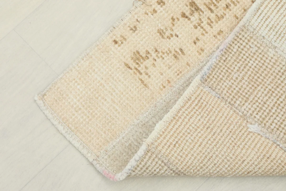 Corner of the rug folded over to reveal the front and back textures