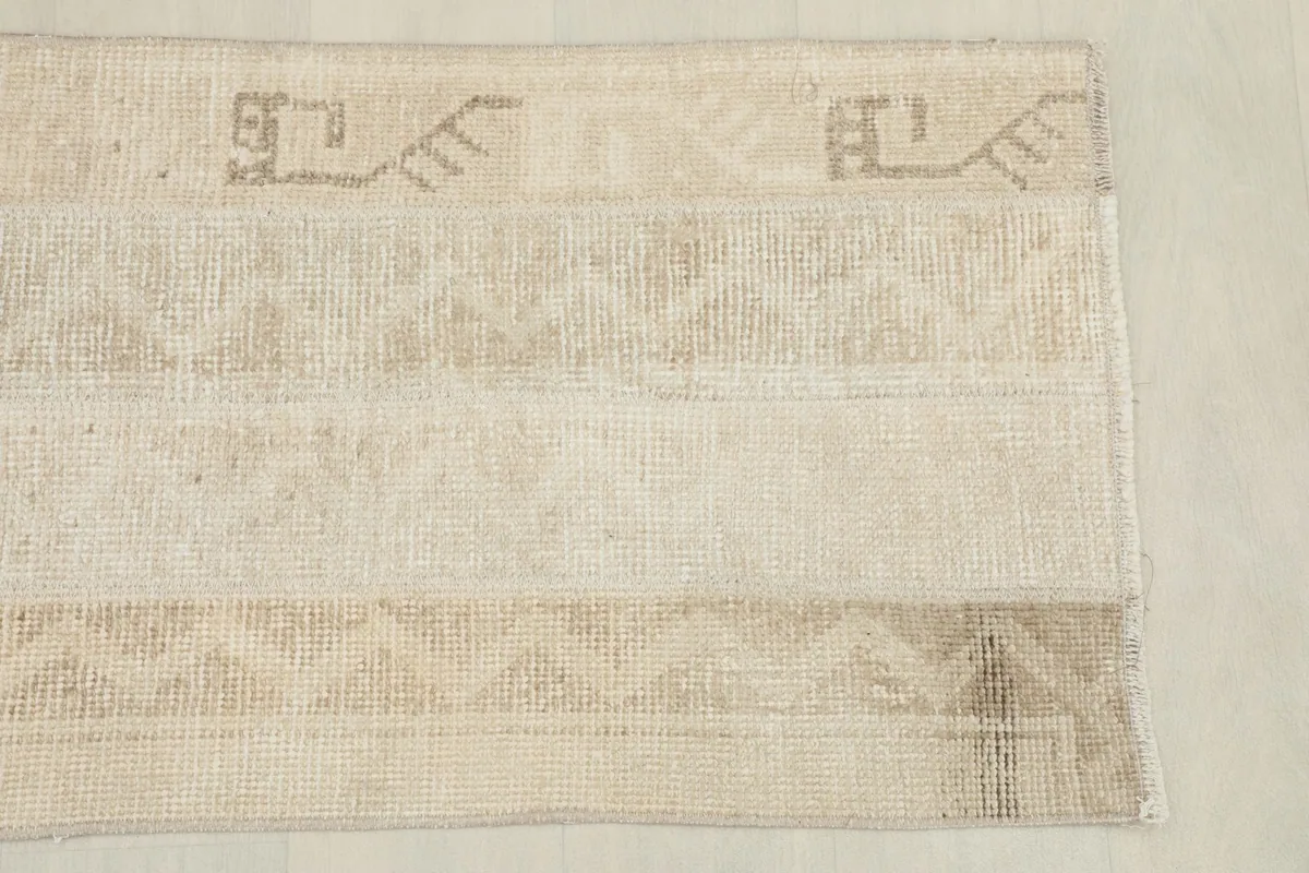 Detailed view of the upper right section of the rug, showcasing subtle geometric patterns and colors.
