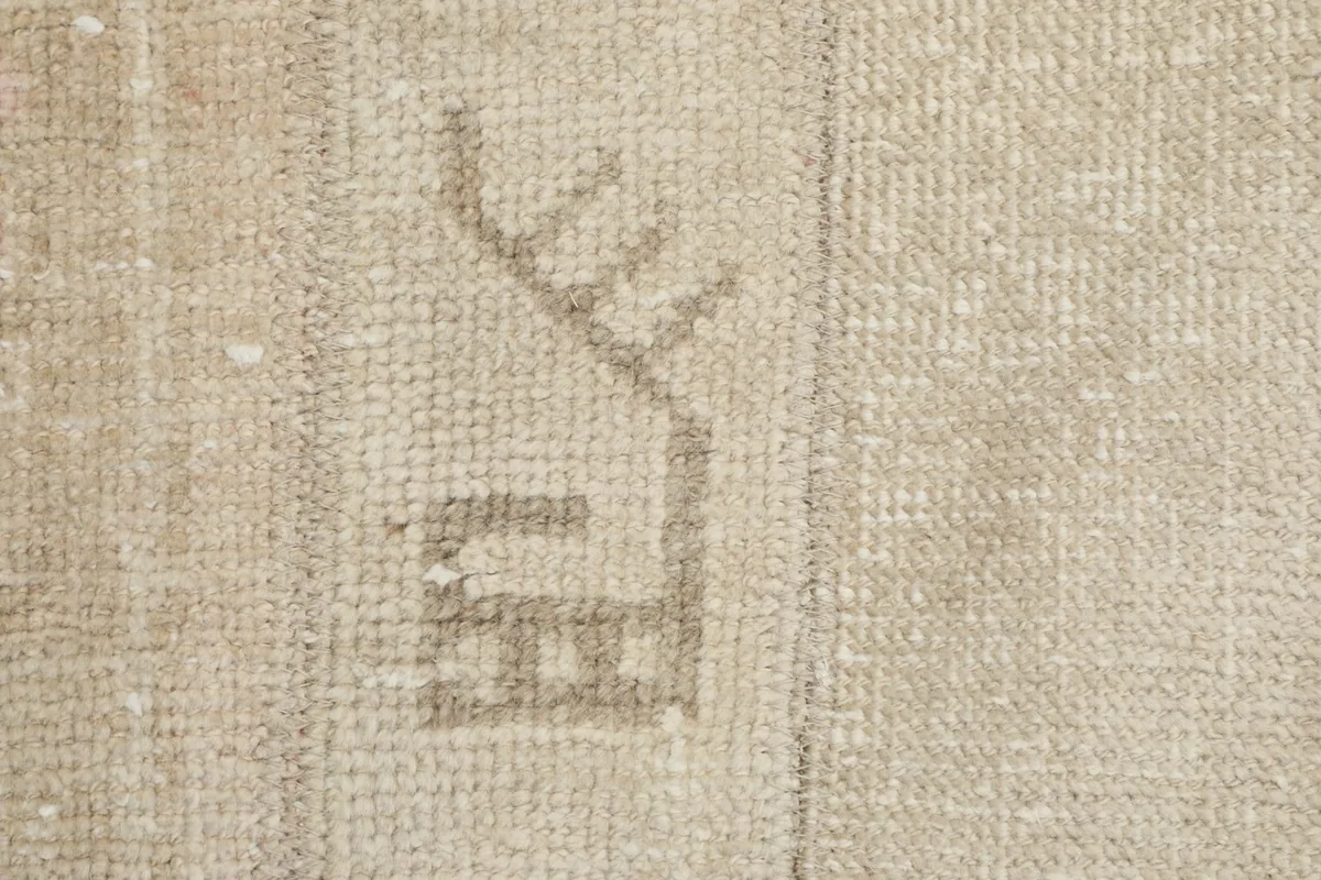 Detailed view of a single gray geometric motif and the wool pile texture