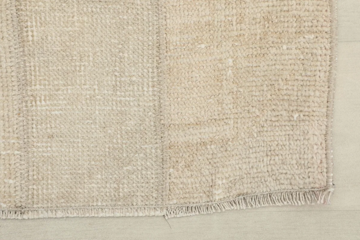 Close-up of the short fringes and edge of the vintage hand-knotted rug