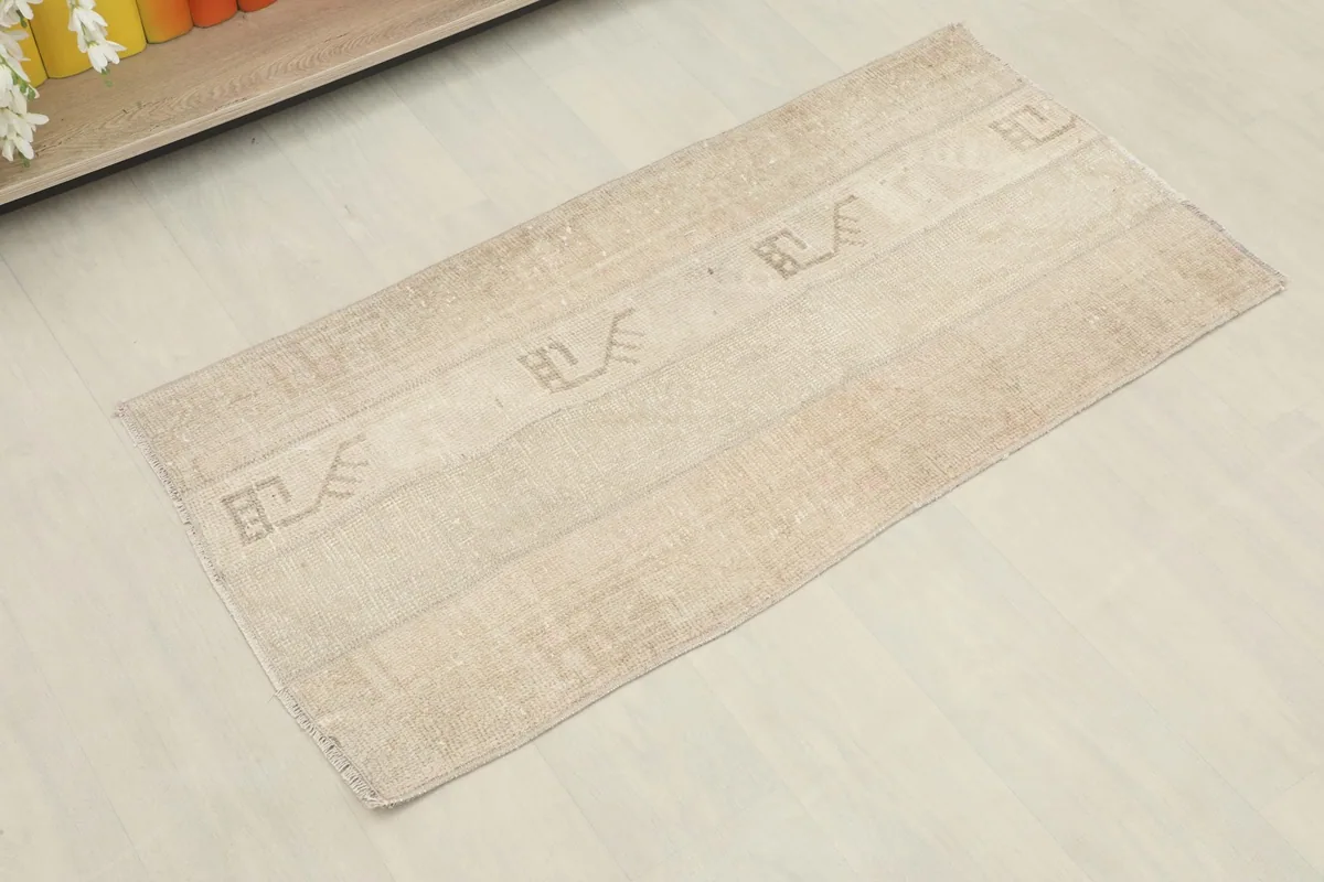 Slightly angled overhead view of the beige and tan patchwork rug