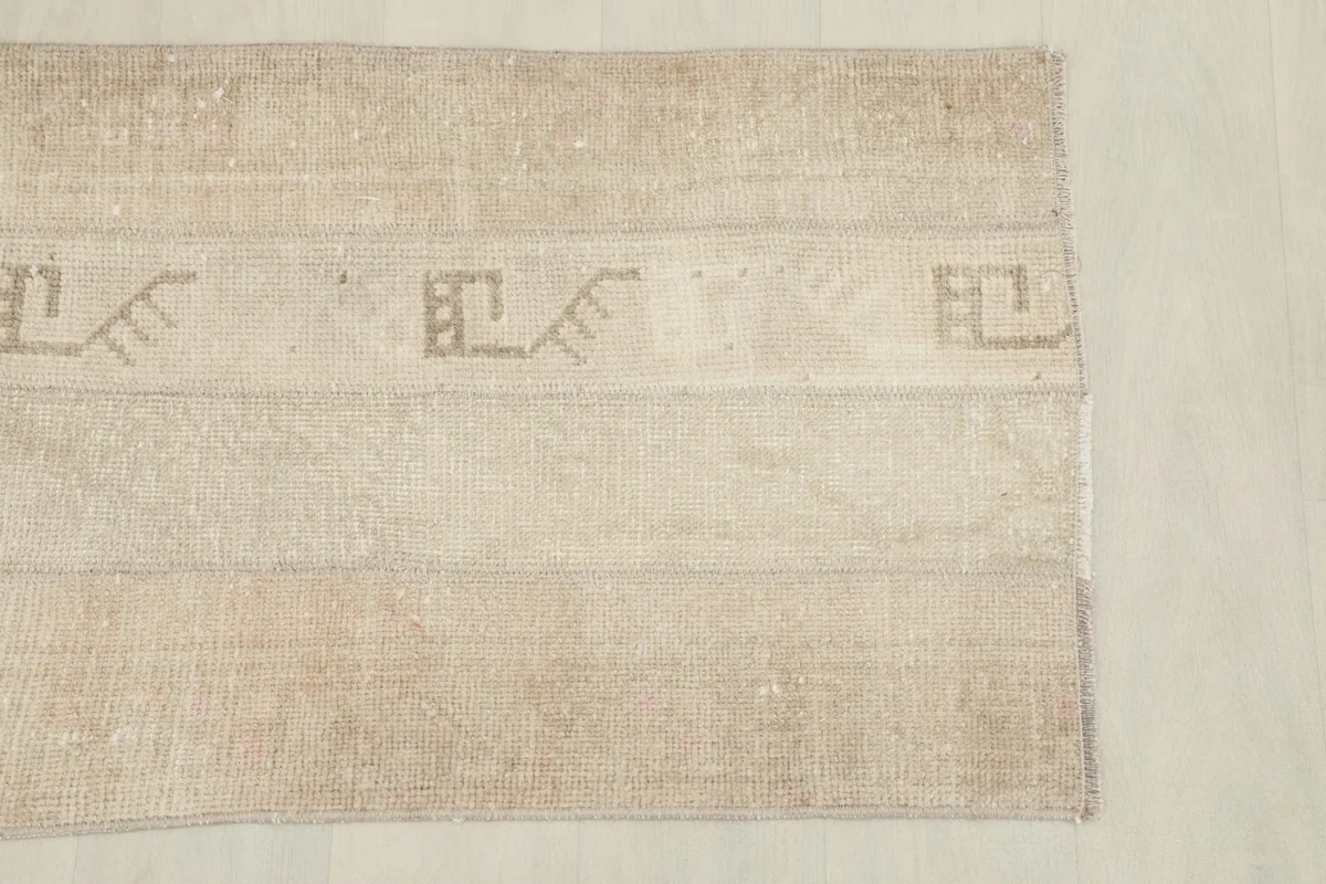 Overhead shot of one end of the rug, showing the geometric patterns and color variations