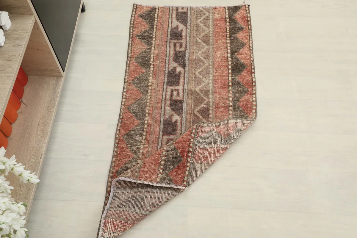 The rug folded to show its flexibility and the consistent pattern from an overhead perspective.