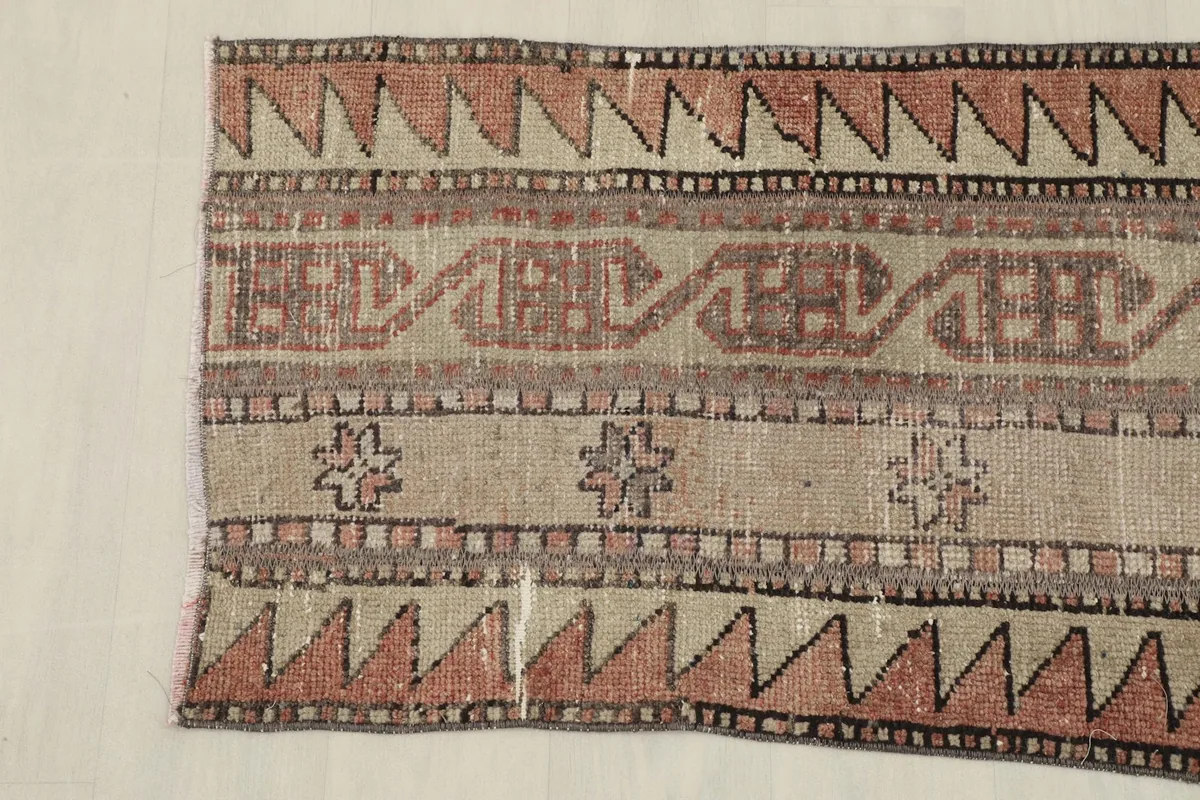 Close-up of the rug's texture and individual knots, revealing the vintage character