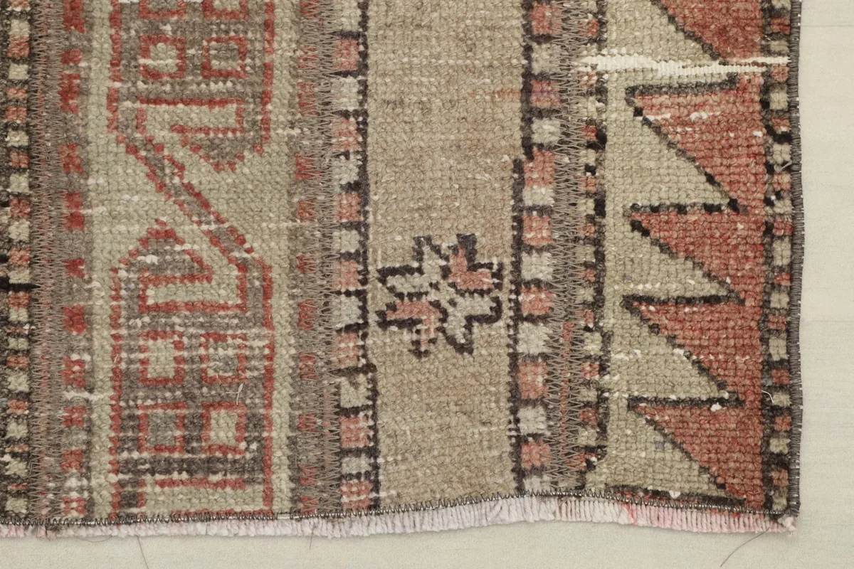 Detailed section of the rug, focusing on a unique tribal emblem within the design